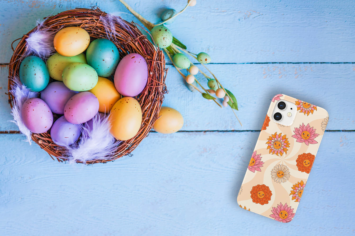 Far Out Floral Smiley Face Phone Case on an iPhone. It is laying on a blue table next to a basket full of Easter eggs.