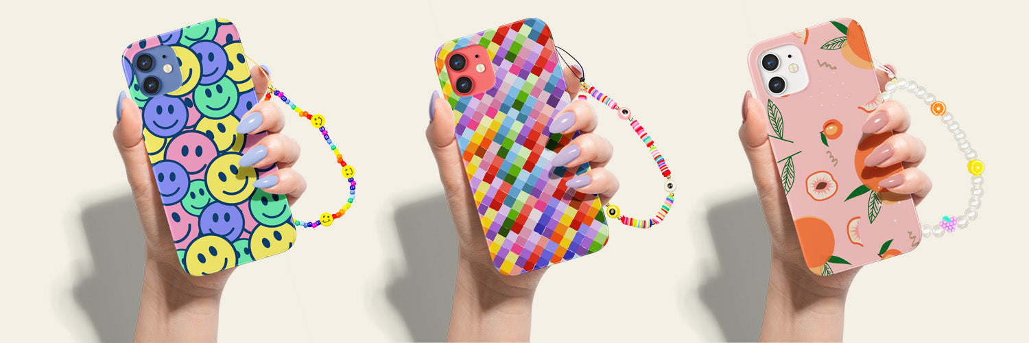 Rainbow Smiles Phone Charm on a Groovy Smiles Phone Case, Eye Candy Phone Charm on a Rainbow Brick Roads Phone Case, and Juicy Pearls Phone Charm on a Just Peachy Phone Case